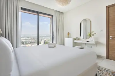 a white bedroom with a large bed and a large window at STAY BY LATINEM Luxury 2BR Holiday Home OPA 305 Near Downtown in Dubai