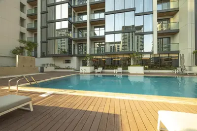 a swimming pool in front of a building at STAY BY LATINEM Luxury 2BR Holiday Home OPA 305 Near Downtown in Dubai