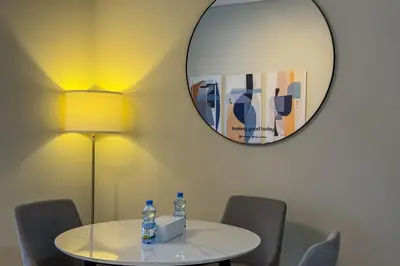 a table with two bottles of water and a mirror at Stylish 1B in J one With Balcony & Canal View in Dubai