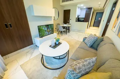 a living room with a couch and a table at Stylish 1B in J one With Balcony & Canal View in Dubai