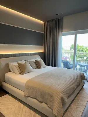 a bedroom with a large bed and a balcony at Luxury 4 Bedroom Villa The Springs Dubai in Dubai