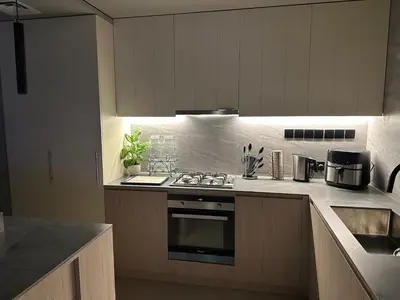 a kitchen with a stove top oven next to a counter at Luxury 4 Bedroom Villa The Springs Dubai in Dubai