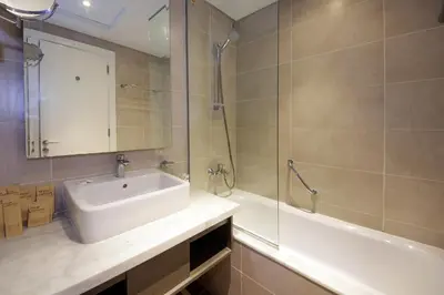 a bathroom with a sink and a shower and a tub at Cozy Studio in Damac Prive - Free Gym & Pool in Dubai