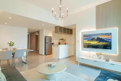 a living room with a large painting on the wall at Luxury2BR BurjKhalifa View Infinity Pool Mall Walk in Dubai