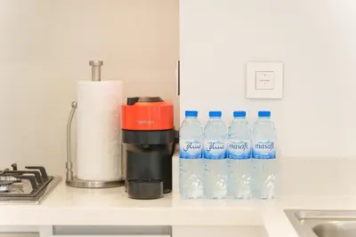 a bunch of bottles of water sitting on a counter at Luxury2BR BurjKhalifa View Infinity Pool Mall Walk in Dubai