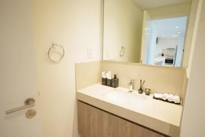 a bathroom with a sink and a mirror at Luxury2BR BurjKhalifa View Infinity Pool Mall Walk in Dubai