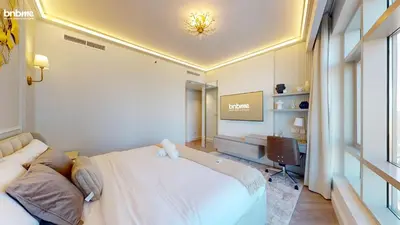 a bedroom with a large bed and a desk at bnbmehomes - The Lofts Central in Dubai