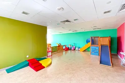 a room with colorful walls and a play room with a slide at bnbmehomes - The Lofts Central in Dubai