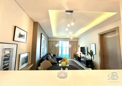 a living room with a teddy bear sitting on a couch at 1 Bedroom Apartment in Paramount Tower - A in Dubai