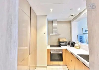 a kitchen with a sink and a stove at 1 Bedroom Apartment in Paramount Tower - A in Dubai