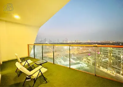 a balcony with two chairs and a view of a city at 1 Bedroom Apartment in Al Jaddaf - High-Floor with Dubai Skyline View in Dubai