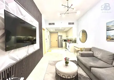 a living room with a couch and a tv on a wall at 1 Bedroom Apartment in Al Jaddaf - High-Floor with Dubai Skyline View in Dubai