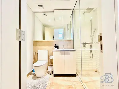 a bathroom with a toilet and a sink and a shower at Stylish 2 Bedroom Apartment in the Heart of JVC - with swimming pool, fully equipped gym, outdoor steam room, kids play area & lots more in Dubai