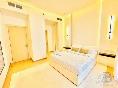 a bedroom with a large white bed in a room at Stylish 2 Bedroom Apartment in the Heart of JVC - with swimming pool, fully equipped gym, outdoor steam room, kids play area & lots more in Dubai