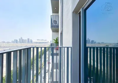 a balcony with a view of the city at Stylish 2 Bedroom Apartment in the Heart of JVC - with swimming pool, fully equipped gym, outdoor steam room, kids play area & lots more in Dubai