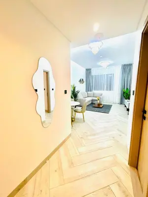 a living room with a mirror on the wall at Stylish 1 Bedroom Apartment in the Heart of JVC in Dubai