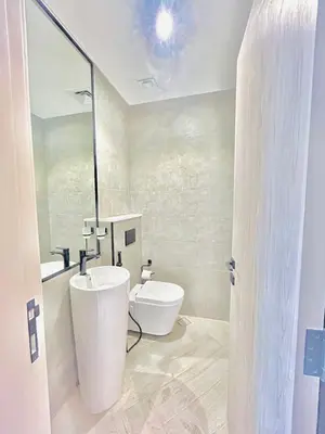 a bathroom with a white toilet and a sink at Stylish 1 Bedroom Apartment in the Heart of JVC in Dubai