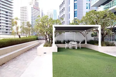 a gazebo with a table and chairs on a lawn at 2 Bedroom Apartment with Canal View in Business Bay in Dubai