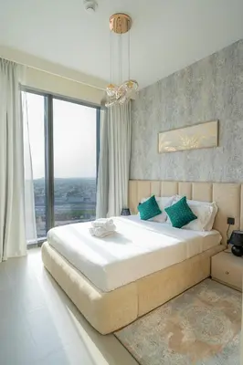 a bedroom with a large bed with a large window at Elegant Downtown Escape 1BR w Balcony, Pool & Gym in Dubai