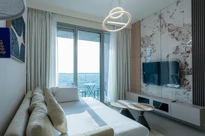 a hotel room with a bed and a tv at Elegant Downtown Escape 1BR w Balcony, Pool & Gym in Dubai
