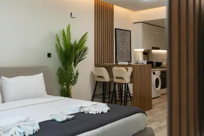 a bedroom with a bed and a kitchen with a counter at Urban Studio - Business Bay in Dubai