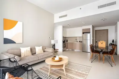 a living room with a couch and a table at The Grand Luxury Residential I1Bedroom I High Floor I Water View I Tennis & Badminton Courts I Rooftop Lounge in Dubai