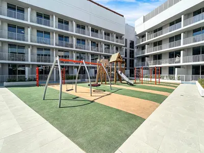an empty playground in front of a building at Bright Modern Studio in the Heart of JVC in Dubai