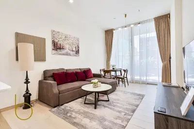 a living room with a couch and a table at Bookable - 1 Bedroom Binghatti Crescent in Dubai