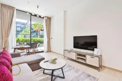 a living room with a couch and a tv at Bookable - 1 Bedroom Binghatti Crescent in Dubai