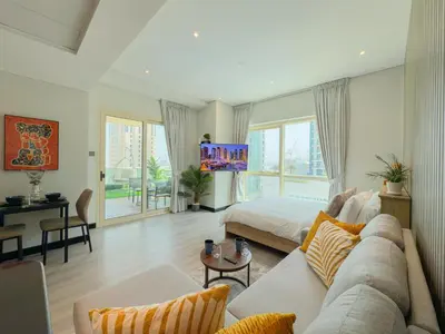 a large living room with a bed and a couch at Luxury Studio Apartment with large Balcony and Sea Views, free Parking, Dubai Marina - JBR in Dubai