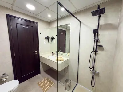 a bathroom with a sink and a glass shower at Luxury Studio Apartment with large Balcony and Sea Views, free Parking, Dubai Marina - JBR in Dubai