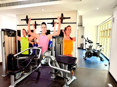 a group of people in a gym lifting weights at Luxury Studio Apartment with large Balcony and Sea Views, free Parking, Dubai Marina - JBR in Dubai