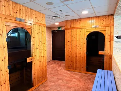 a hallway with wood paneled walls and a blue bench at Luxury Studio Apartment with large Balcony and Sea Views, free Parking, Dubai Marina - JBR in Dubai