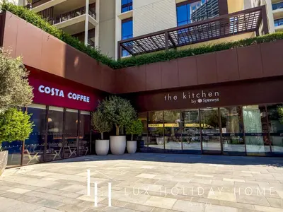 a building with a cotia coffee sign in front of it at LUX The Dubai Creek Beach Suite 2 in Dubai