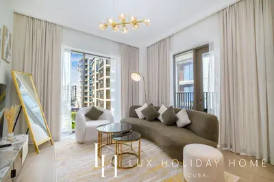 a living room with a couch and a table at LUX The Dubai Creek Beach Suite 2 in Dubai