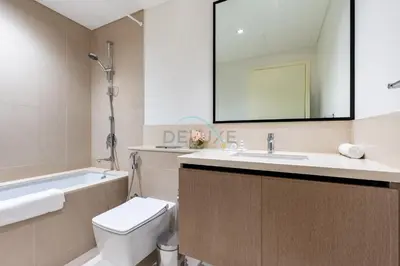 a bathroom with a sink toilet and a mirror at Boulevard Views, Steps from Burj Khalifa & Dubai Mall, Near Metro Station and Few Mins Drive to Dubai Marina - Burj Crown, Downtown Dubai by Deluxe Holiday Homes in Dubai
