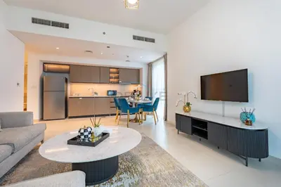 a living room with a couch and a table at Boulevard Views, Steps from Burj Khalifa & Dubai Mall, Near Metro Station and Few Mins Drive to Dubai Marina - Burj Crown, Downtown Dubai by Deluxe Holiday Homes in Dubai