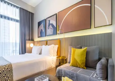 a hotel room with a bed and a couch at Stylish Stay, Walk to Dubai Mall, Downtown in Dubai