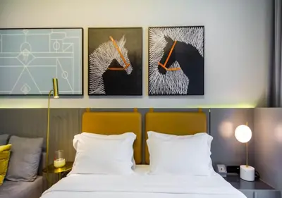 a bedroom with a bed and three paintings on the wall at Stylish Stay, Walk to Dubai Mall, Downtown in Dubai