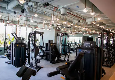 a gym with lots of treadmills and exercise bikes at Stylish Stay, Walk to Dubai Mall, Downtown in Dubai