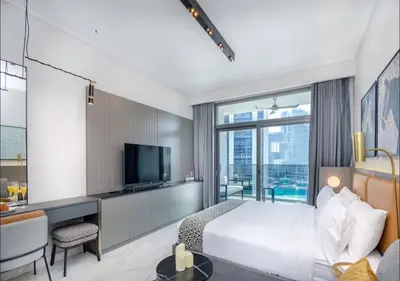 a hotel room with a bed and a television at Stylish Stay, Walk to Dubai Mall, Downtown in Dubai