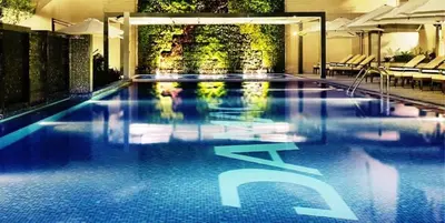 a large swimming pool in a hotel with the word spa at City View Studio on High Floor, Steps from Metro, Beside Water Canal, Quick Downtown Access, The Cosmopolitan, Business Bay by Deluxe Holiday Homes in Dubai