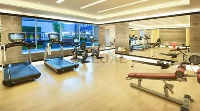 a gym with several treadmills and cardio machines at City View Studio on High Floor, Steps from Metro, Beside Water Canal, Quick Downtown Access, The Cosmopolitan, Business Bay by Deluxe Holiday Homes in Dubai