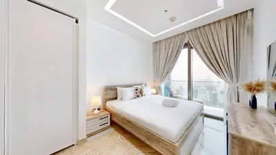a white bedroom with a bed and a window at Marina Gate 2 - High Rise One Bed with Marina View in Dubai
