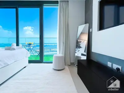 a bedroom with a view of the ocean at Breathtaking Studio with Balcony & Stunning Views in Dubai