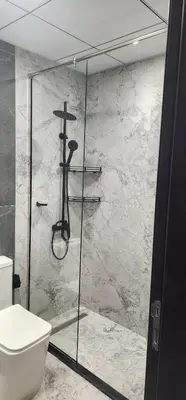 a bathroom with a shower and a toilet at Opalz by danube in Dubai