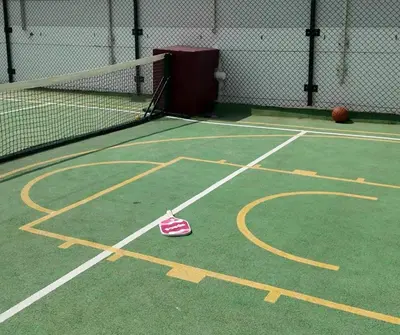 a pair of shoes on a tennis court at Opalz by danube in Dubai