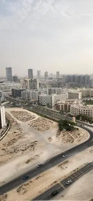 an aerial view of a city with a highway and buildings at Opalz by danube in Dubai