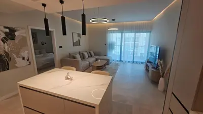 a kitchen and living room with a couch and a table at Urban Sunset, Newly Renovated Central 1BR in Dubai