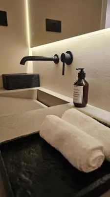 a bathroom with a bottle of soap and a towel at Urban Sunset, Newly Renovated Central 1BR in Dubai